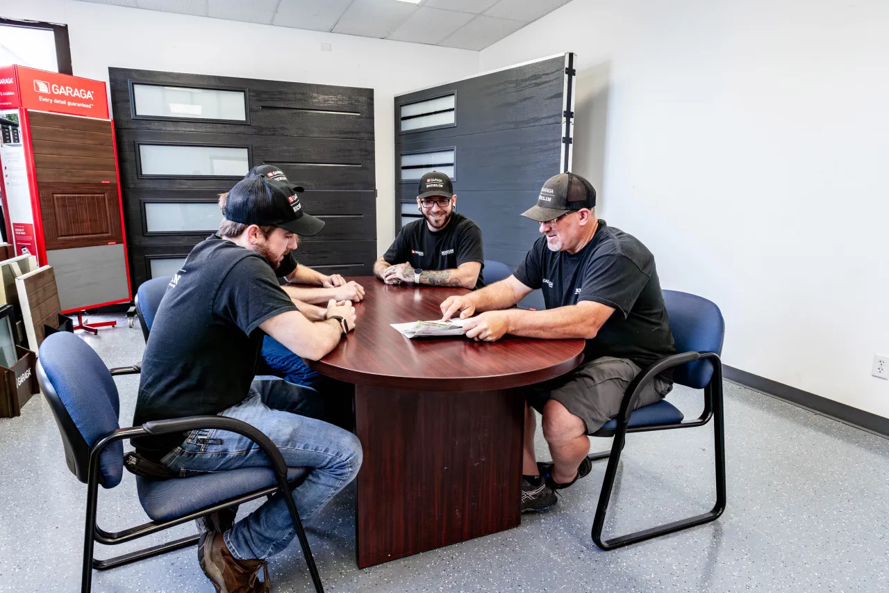 Hicklin Garage Door technicians working together at a table