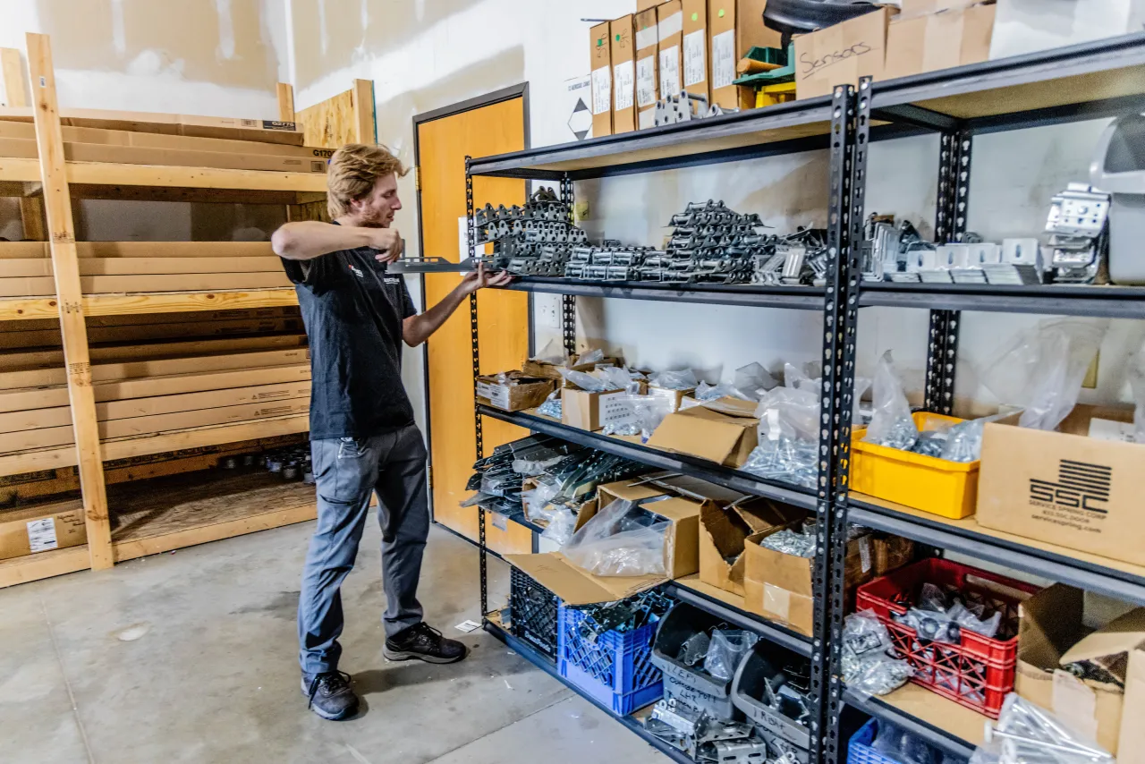 Garage door installer placing hardware in the warehouse